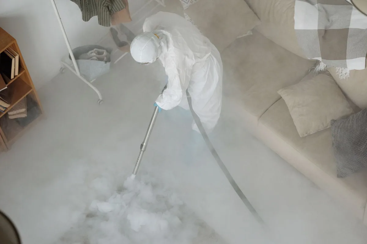 Biohazard cleanup technician in protective equipment, Conrad, MT